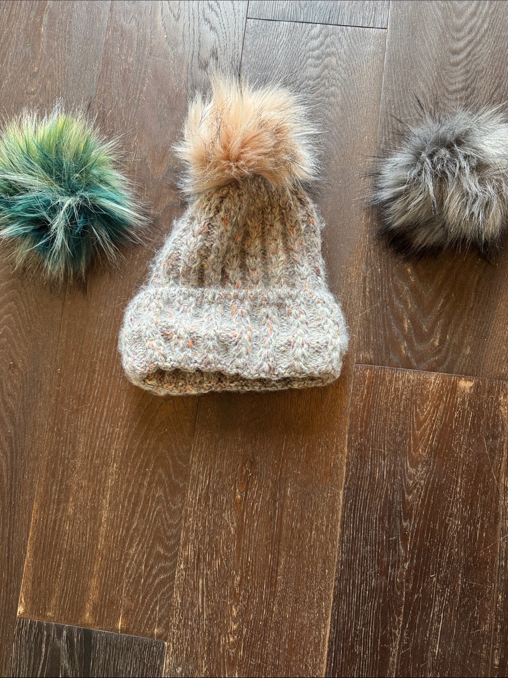 Hat with adjustable poms